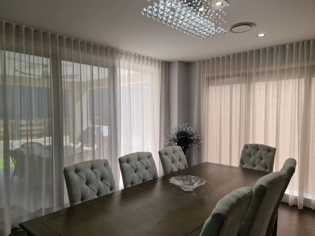 Sheer curtains across a dining room
