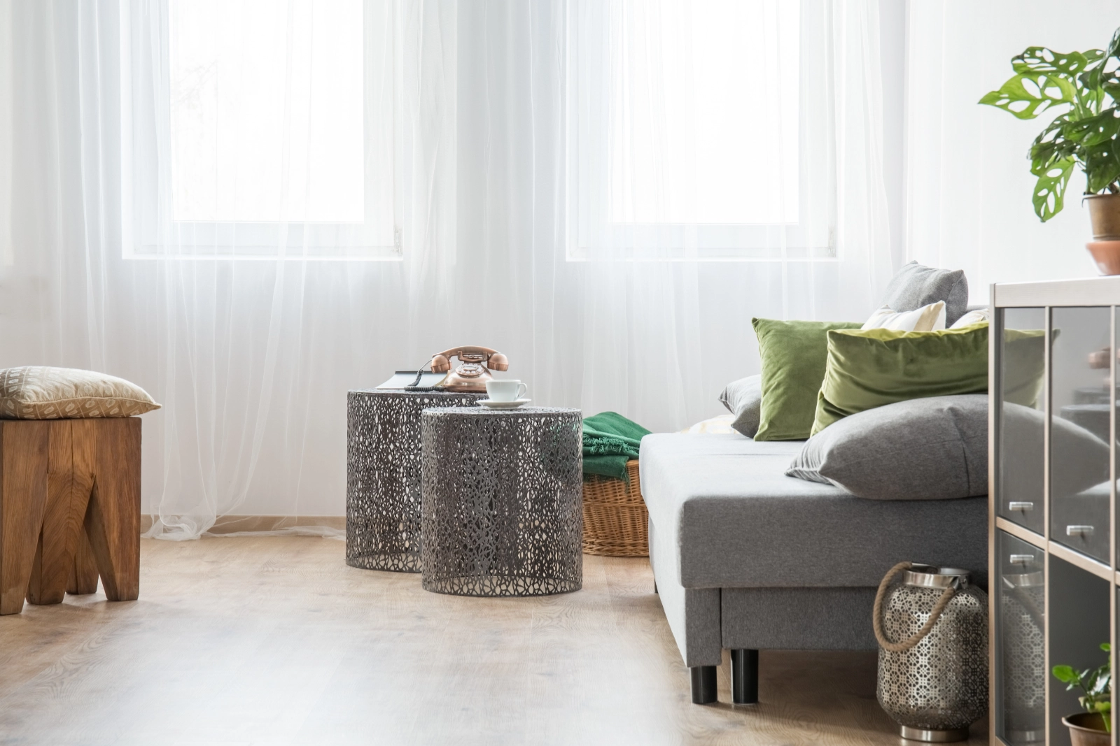White sheer curtains in a relaxed living room with sofa and table