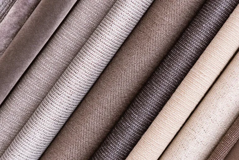 Neutral curtain fabric samples in a range of woven textures and colours