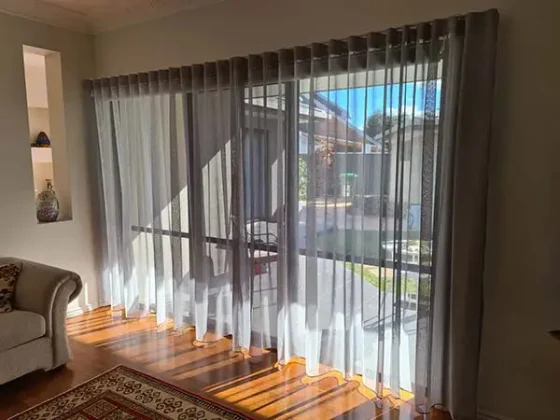 Sheer curtains filtering daylight across a Gold Coast living room door