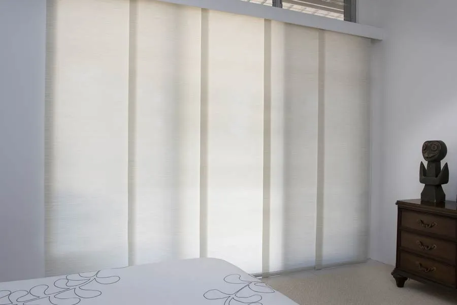 Light panel blinds used as a flexible divider in a bedroom