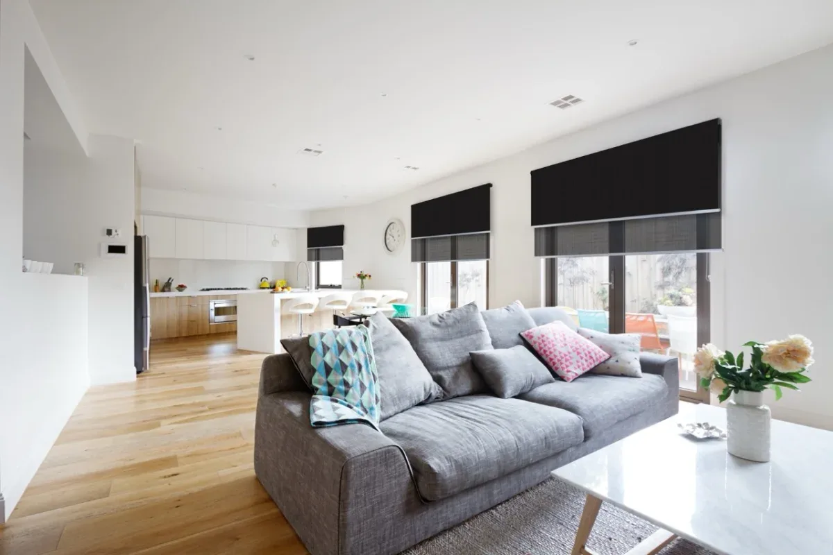 Double roller blinds combining blockout and sunscreen fabrics in a bright living room