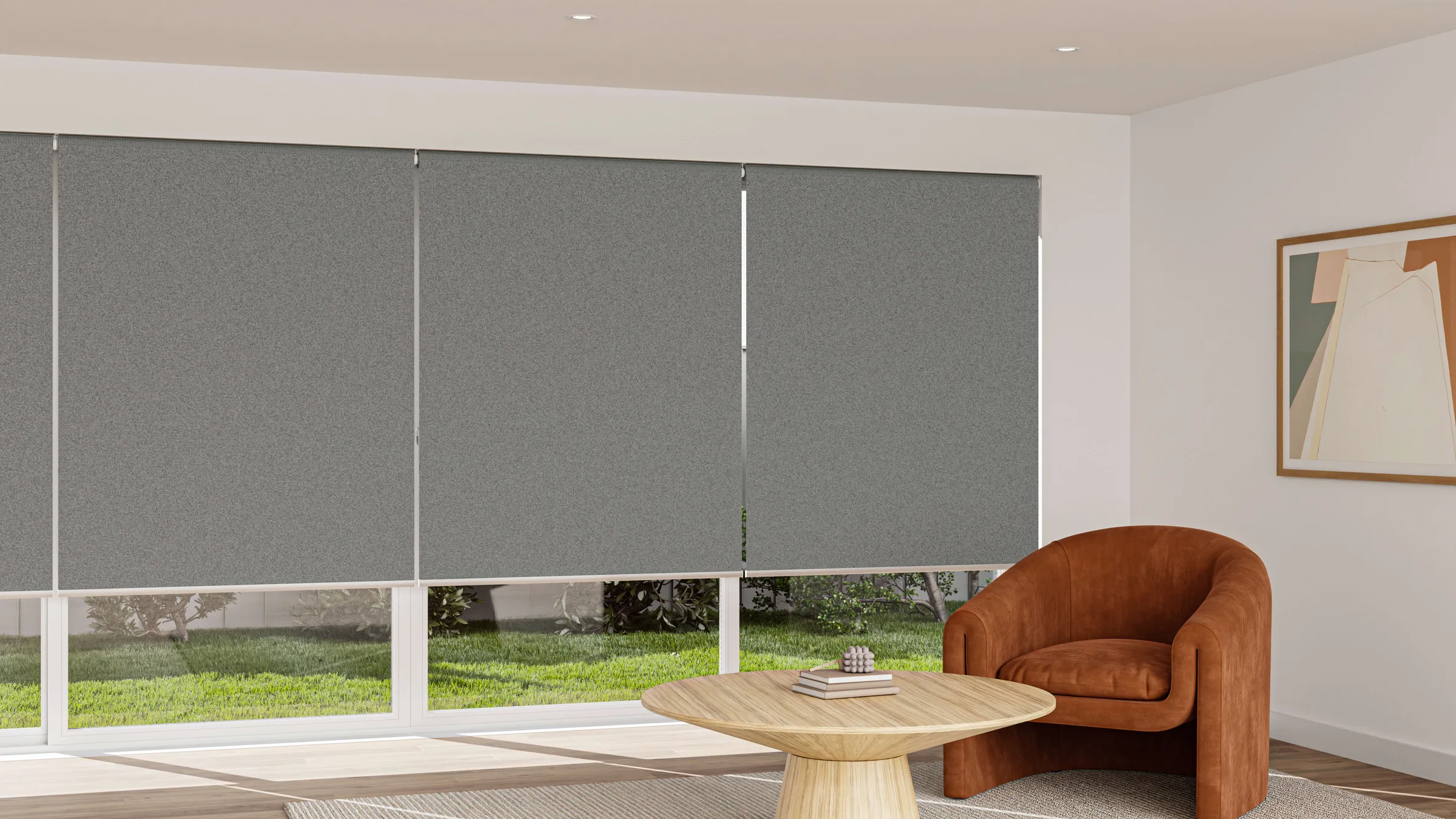 Grey blockout roller blinds fitted across wide living room windows