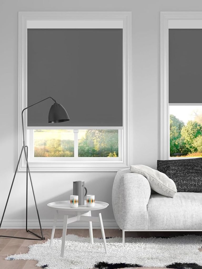 Grey blockout roller blinds fitted to two living room windows