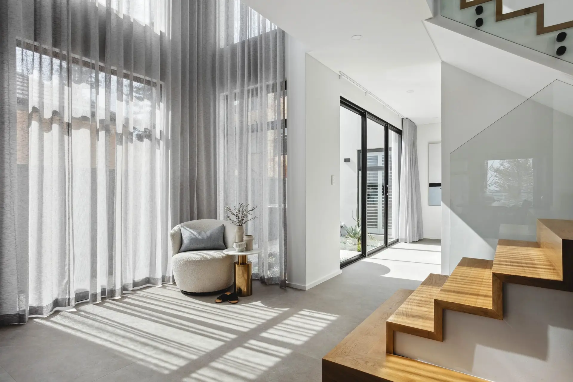 Light grey sheer curtains in a modern home interior