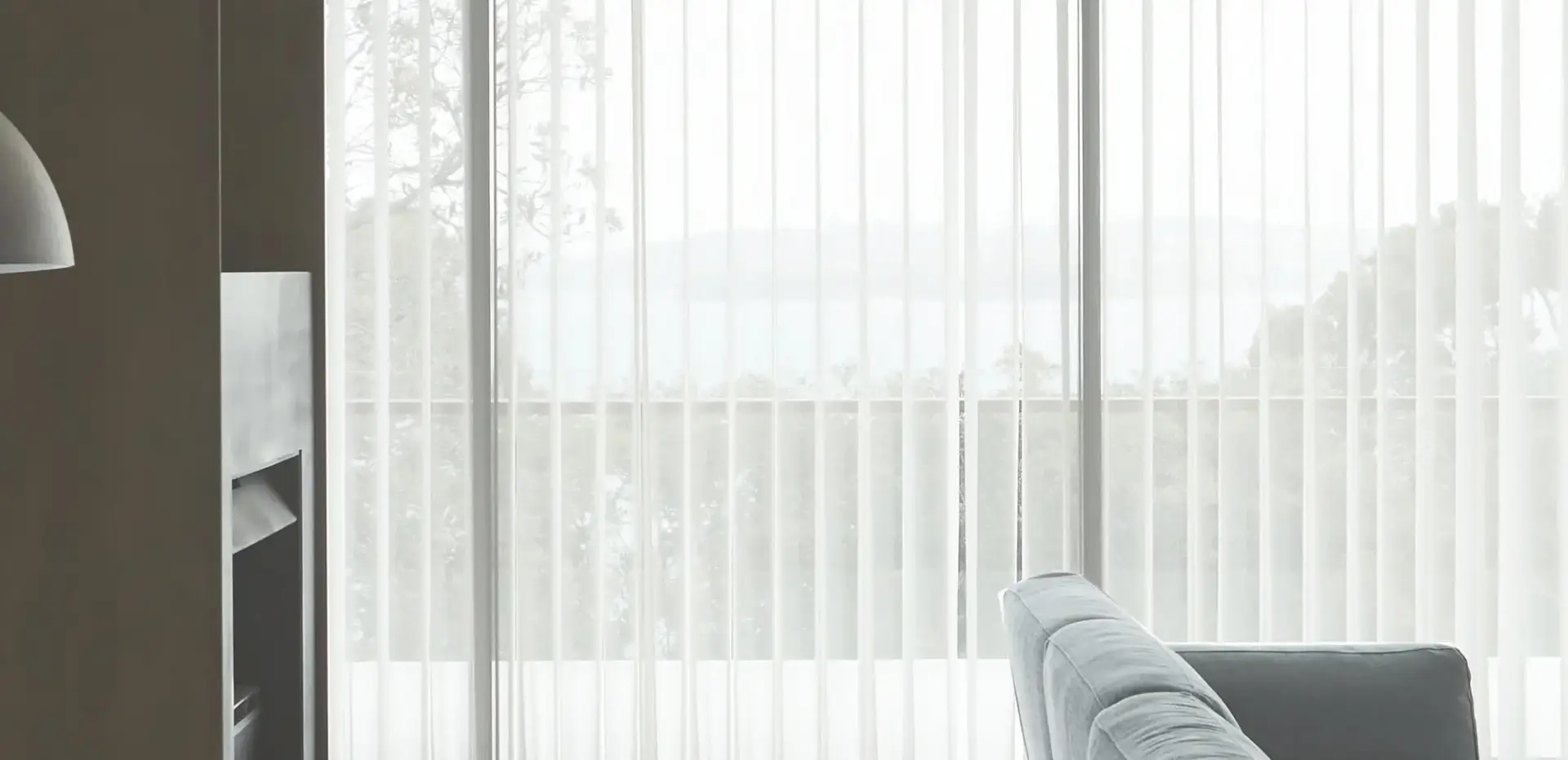 Veri Shades filtering soft daylight across a coastal living room